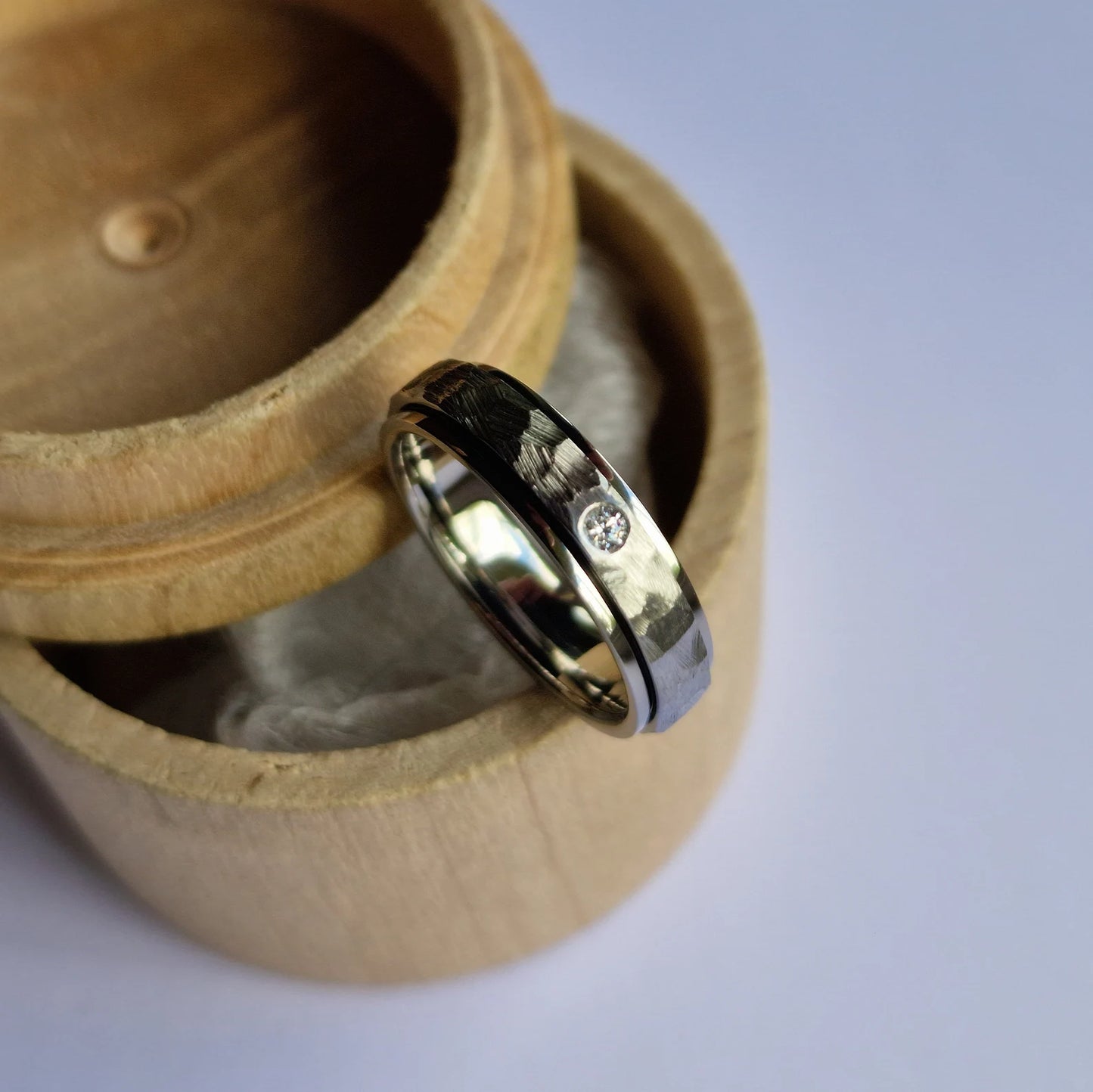 Handmade Flush Set Faceted Titanium Spinner Band.
