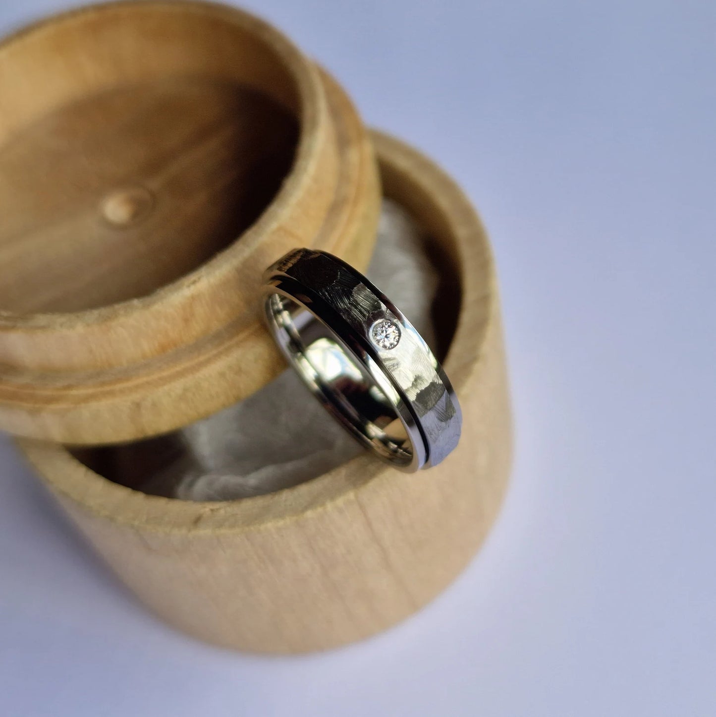 Handmade Flush Set Faceted Titanium Spinner Band.
