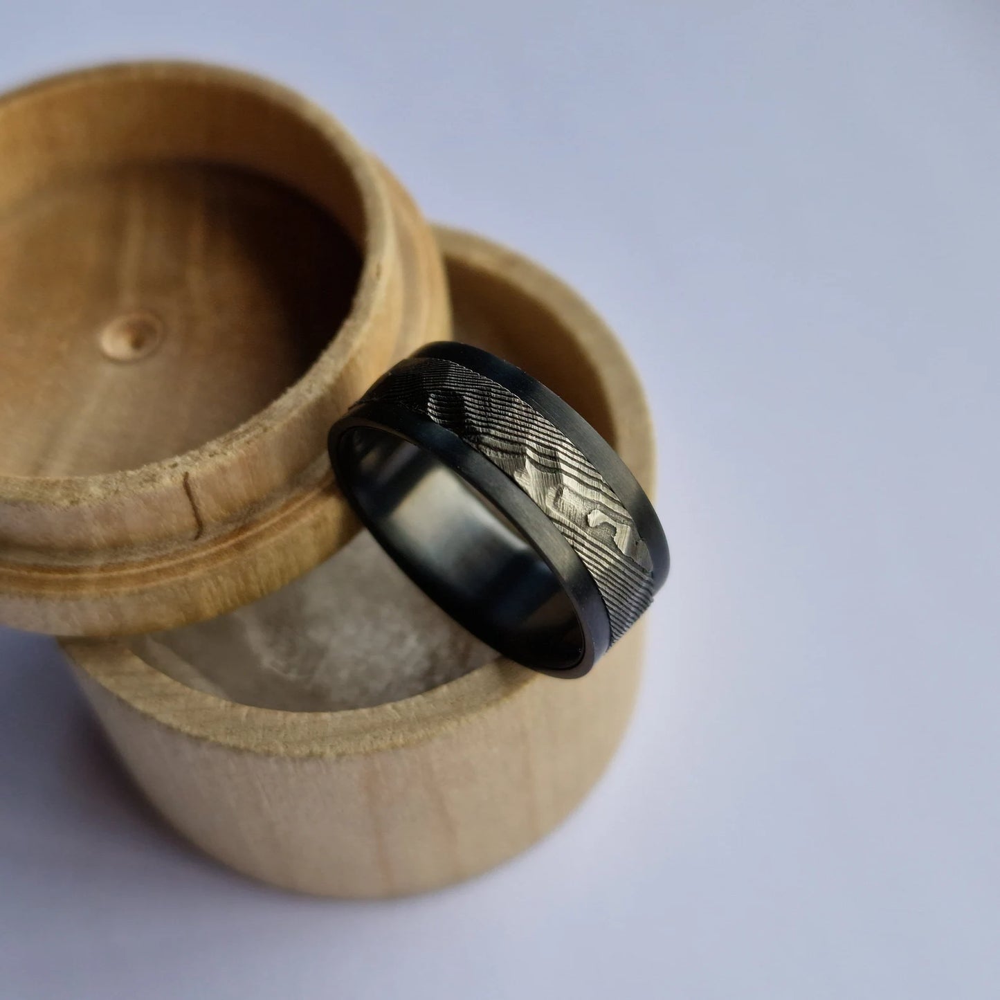 Handmade Rough Finish Faceted Stainless Damascus Steel and Black Zirconium Band.