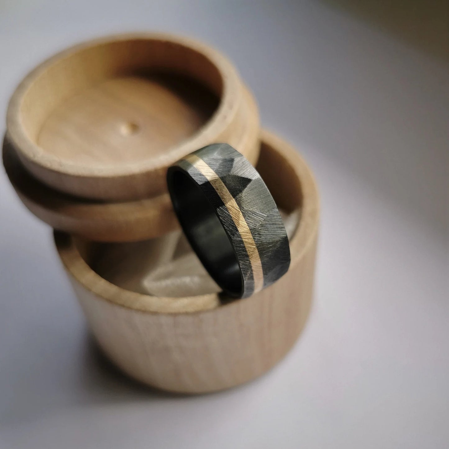 Handmade Faceted Black Zirconium Ring with Solid Gold Channel.