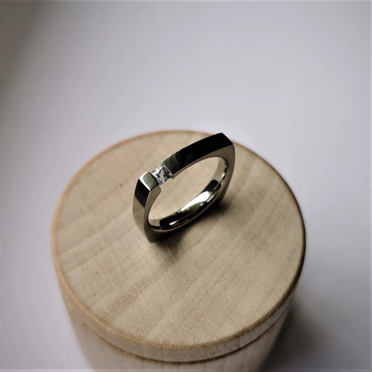 Unique Handmade Brushed Titanium Tension Ring with Square Diamond Cut Stone Setting.