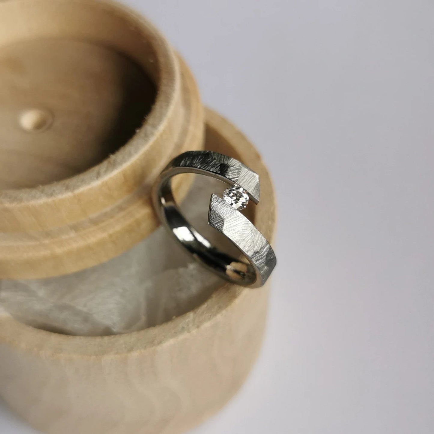 Unique Handmade Faceted Titanium Tension Ring with Round Brilliant Cut Stone Setting.