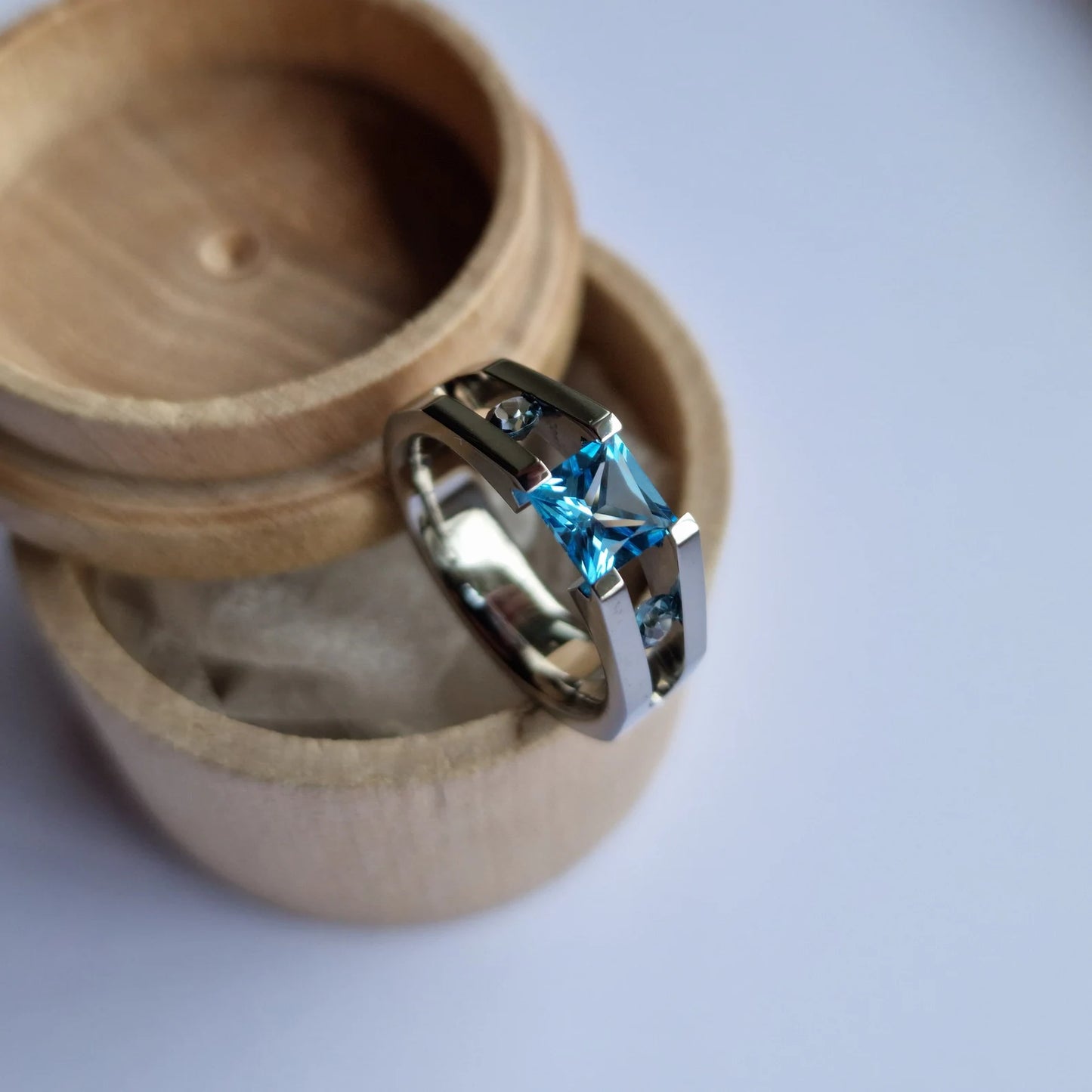 Unique Handmade Polished Titanium Tension Ring with Princess Cut Swiss Blue Topaz and Moissanite Round Brilliant Cut Stone Setting.