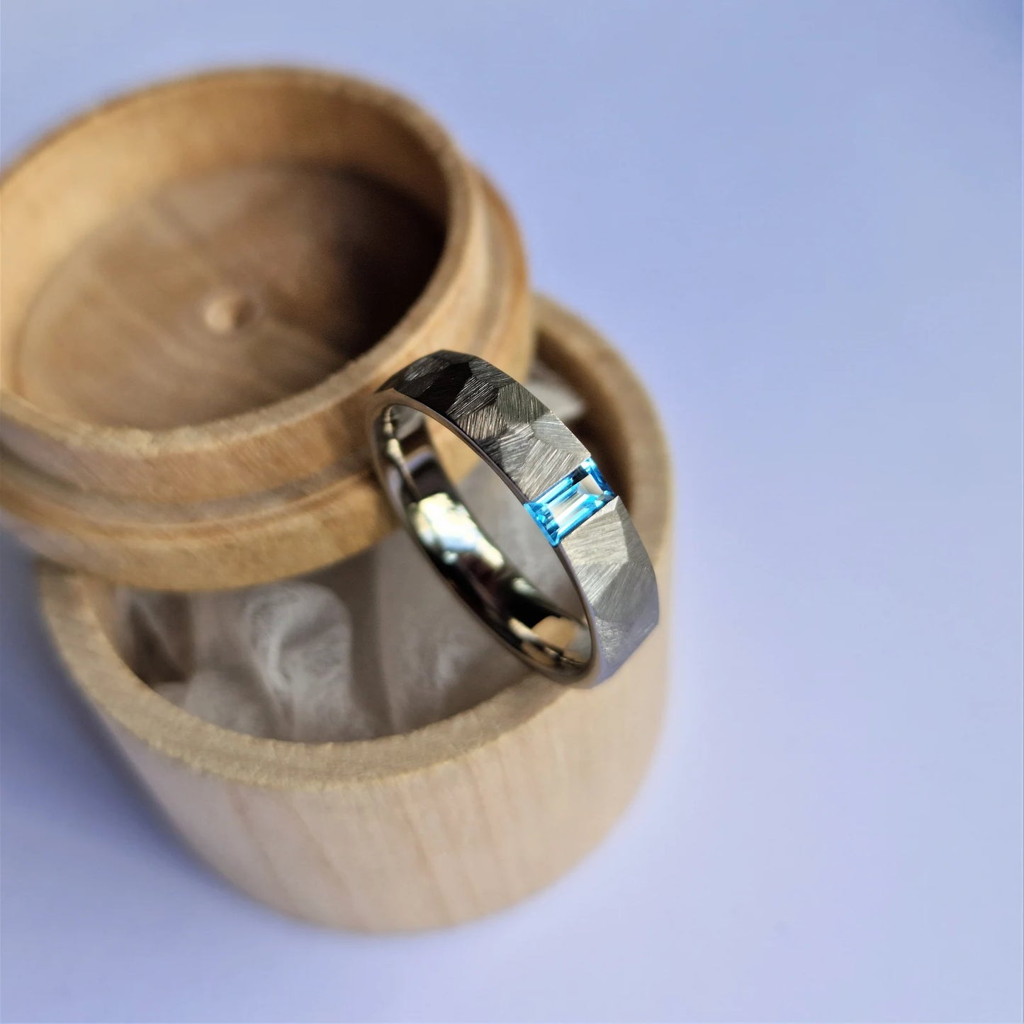 Unique Handmade Faceted Titanium Tension Ring with Baguette Cut Stone Setting.