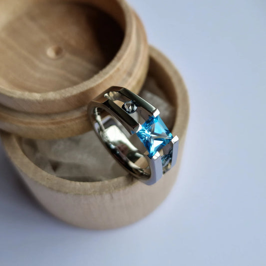 Unique Handmade Polished Titanium Tension Ring with Princess Cut Swiss Blue Topaz and Moissanite Round Brilliant Cut Stone Setting.