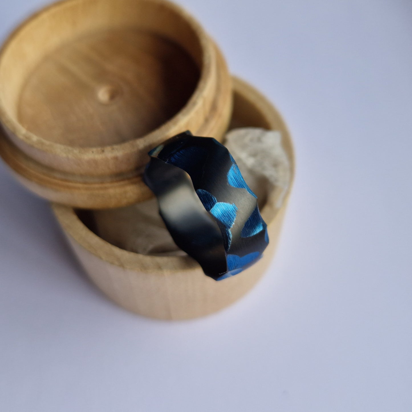 Handmade Rough Finish Faceted Black Zirconium Band with Deep Blue Facets.