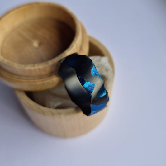 Handmade Rough Finish Faceted Black Zirconium Band with Deep Blue Facets.